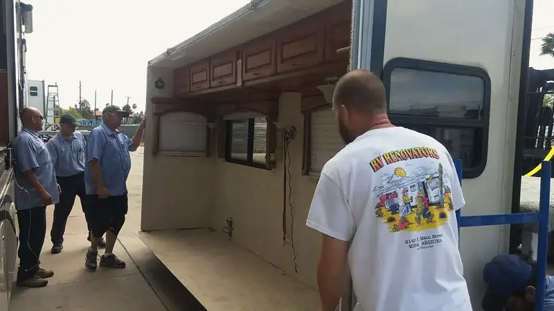 RV Renovators technicians rebuilding the rear wall and cabinets of a fifth wheel